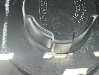 Cap of a Frightliner Cascadia fuel or DEF/engine cap visible with embossed Freightliner text