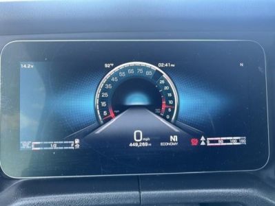 Dashboard display in a Freightliner Cascadia showing a digital speedometer with 0 mph, 449,269 mi, economy, fuel gauge, and warning icons.