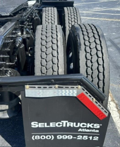 Rear view of a Freightliner Cascadia truck tractor showing dual rear axles and part of the fender; visible are the SelectTrucks Atlanta plate and contact number (800) 999-2512.