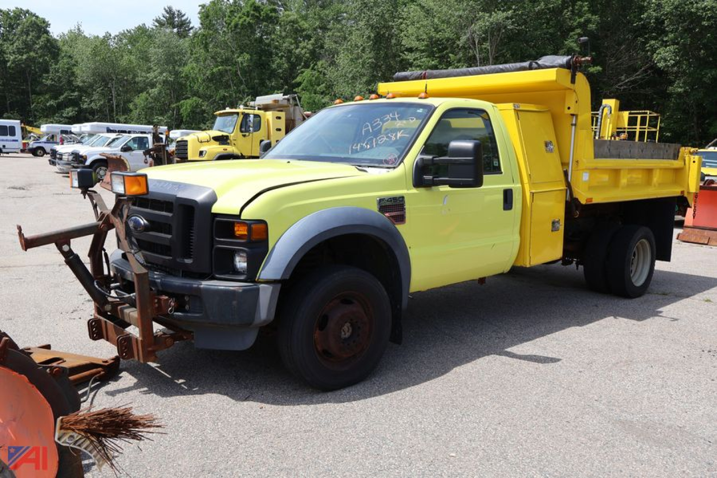 2009 Ford F450 dump truck with a yellow dump bed and front cab, side view