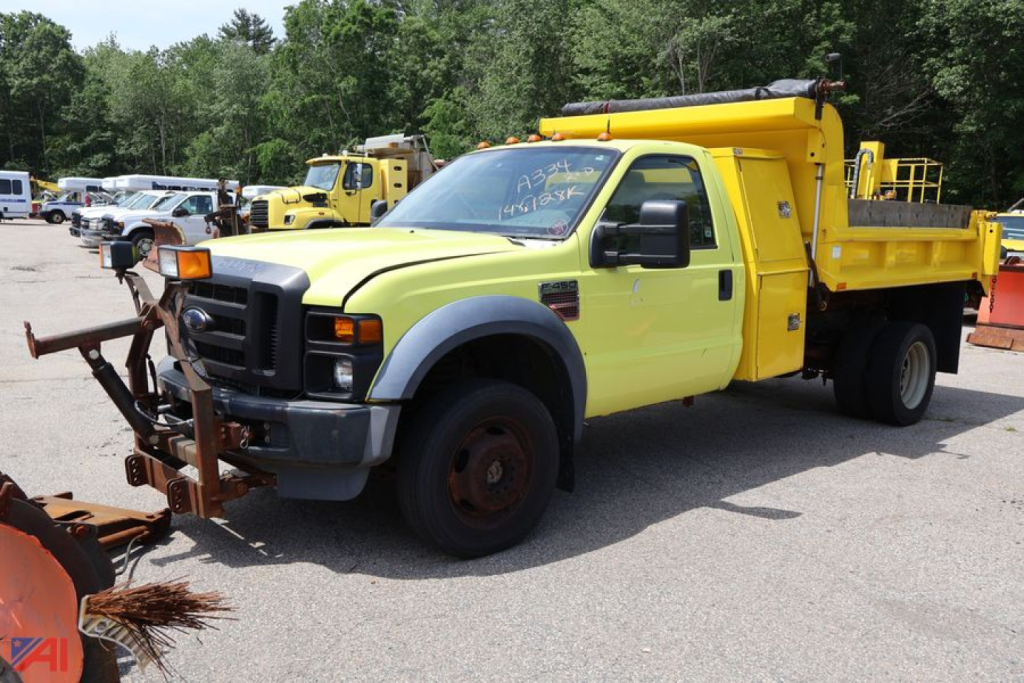 2009 Ford F450 dump truck with a yellow dump bed and front cab, side view