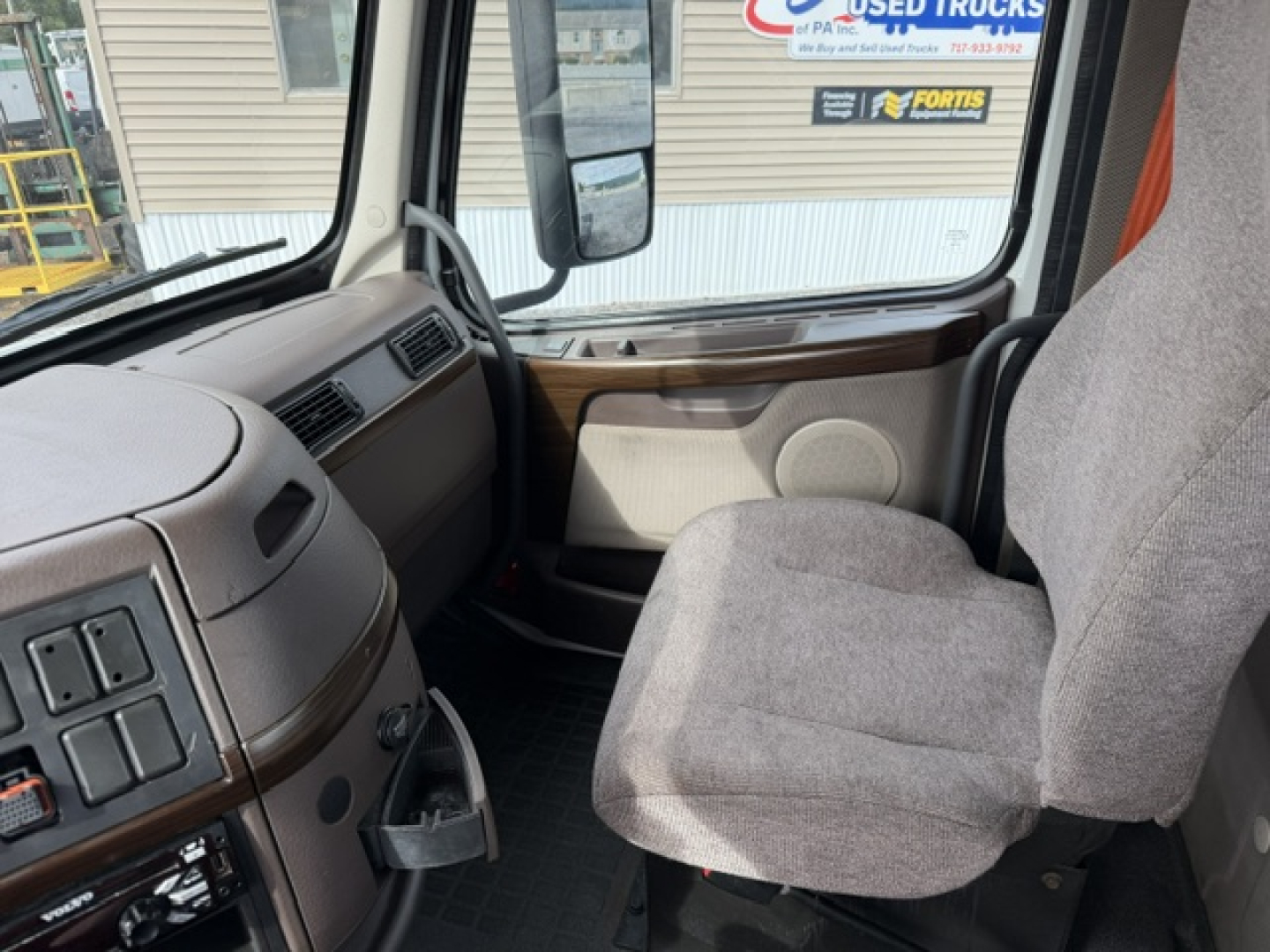 Volvo VNL64T300 interior driver seat and dashboard view.