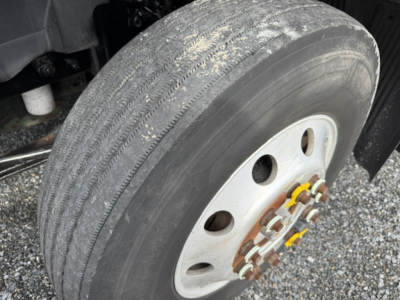 Volvo VNL truck wheel and tire with hub and lug nuts in view