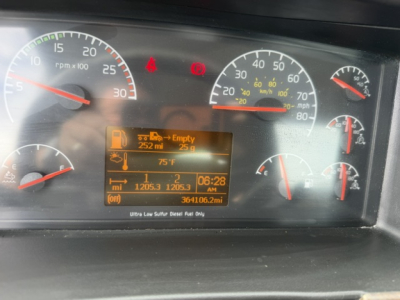 Dashboard of a 2016 Volvo VNL64T300 showing digital display with fuel, temperature, and mileage readouts; gauges indicate rpm, speed, and engine status icons.