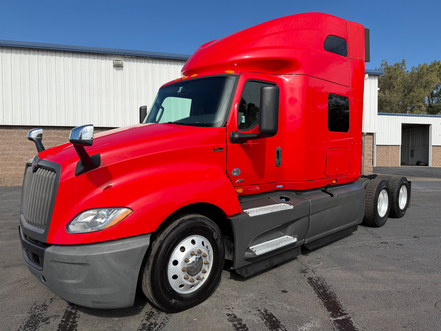 Red 2020 International LT625 conventional sleeper truck side view showing cab and dual rear axles.