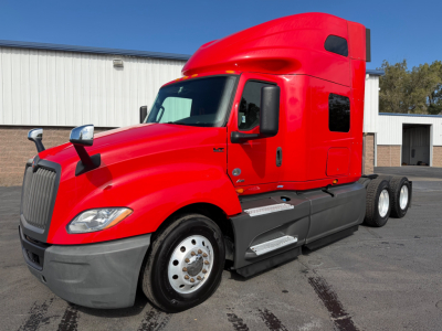 Red 2020 International LT625 conventional sleeper truck side view showing cab and dual rear axles.