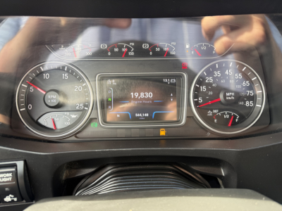 Dashboard of 2020 International LT625 showing speedometer, tachometer, and central digital display with 19,830 miles, engine hours, and warning indicators.