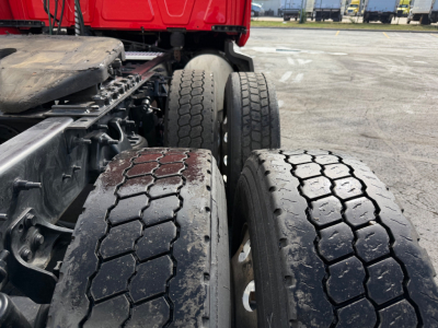 Truck axle and dual rear tires of a 2020 International LT625 Conventional Sleeper showing dual rear wheels and tread pattern.