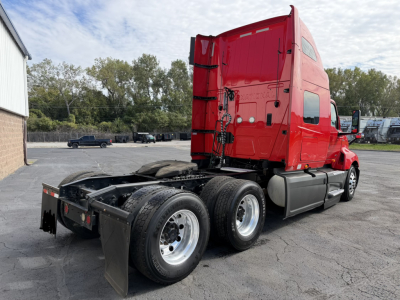 International LT625 truck tractor side/rear view showing red cab and dual rear axles with fifth-wheel and chassis, no visible damage.