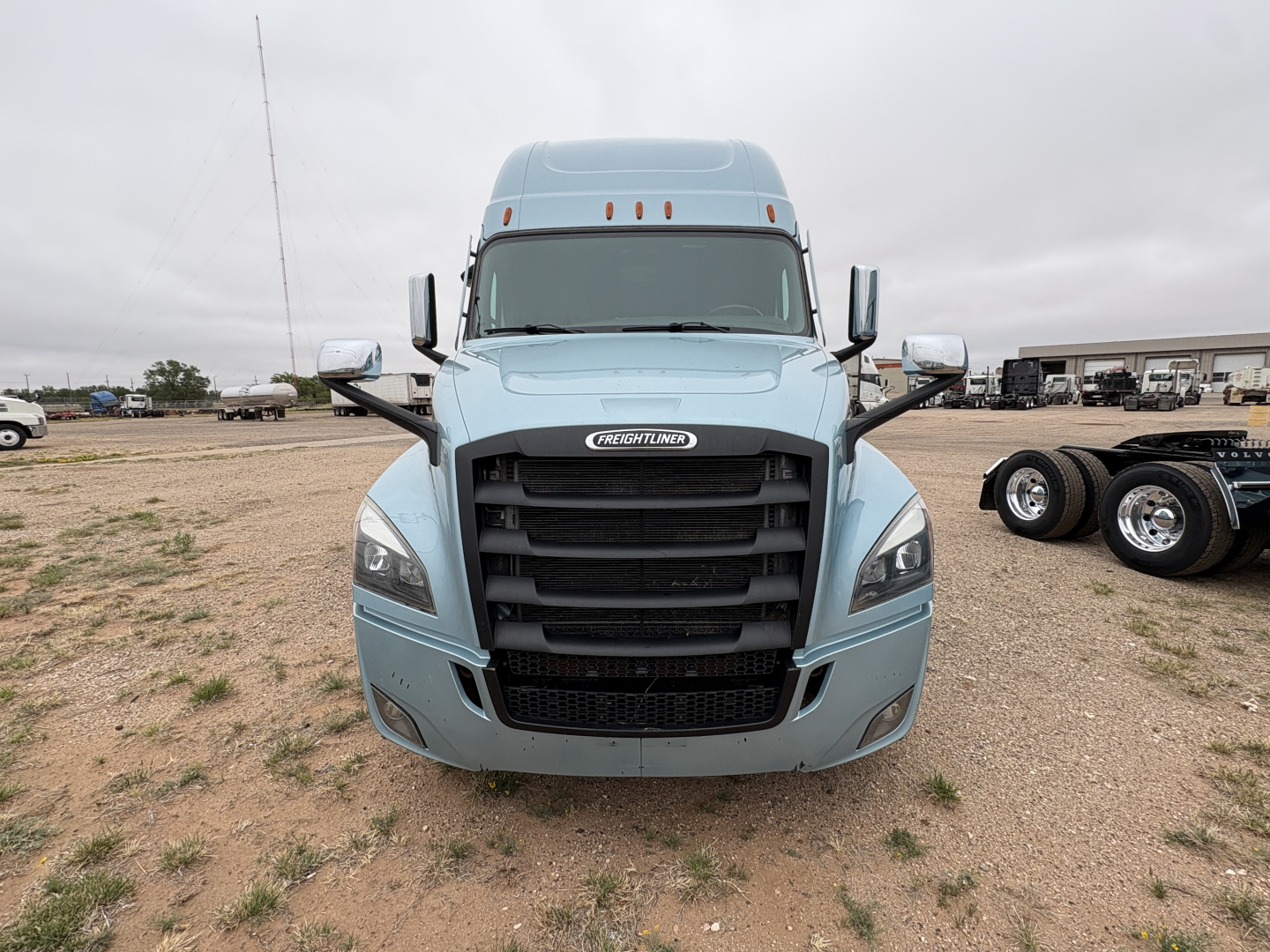 Freightliner Cascadia 126 truck front view showing grille and headlights, light blue exterior.