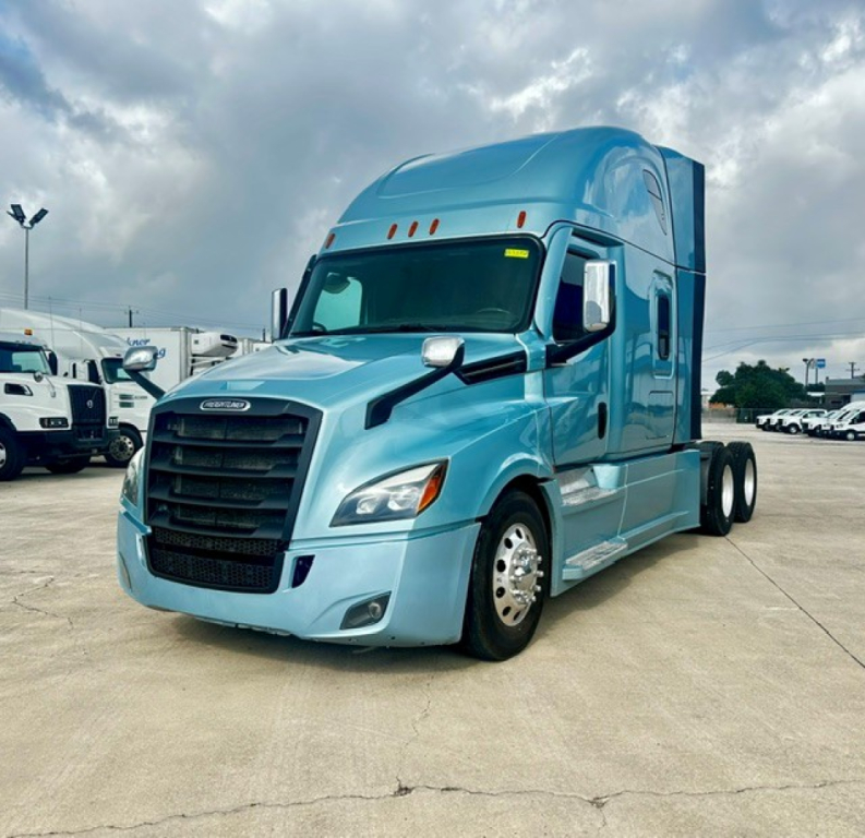 Freightliner Cascadia 126 tractor in light blue, front-three-quarters view, no trailer attached, large black grille, sleeper cab, side mirrors, daytime running lights.