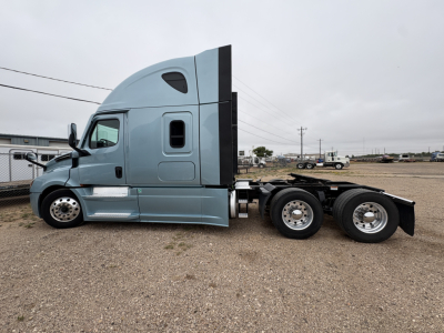 Freightliner Cascadia 126 tractor cab in blue-gray side view showing sleeper cab and attached rear chassis with dual rear axles.