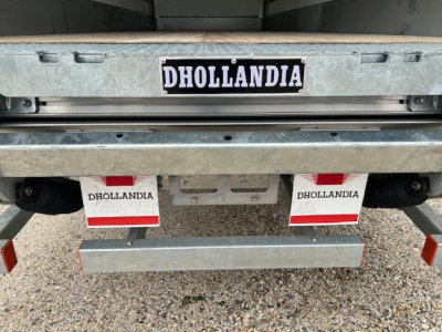 Rear view of a 2025 Mack MD6 truck showing Dhollandia tailgate unit and DHOLLANDIA mud flaps with red/white reflectors.