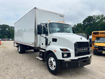 Mack MD6 box truck in a lot showing cab and large white cargo box with black bumper and MACK grille.