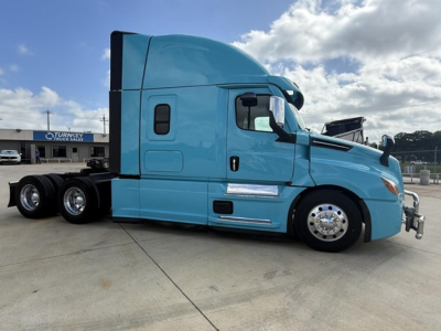 Freightliner Cascadia 126 sleeper cab truck side view with turquoise paint and chrome wheels.