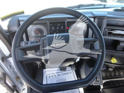 Mack MD6 truck cockpit showing steering wheel, dashboard, gauges, and control panel.
