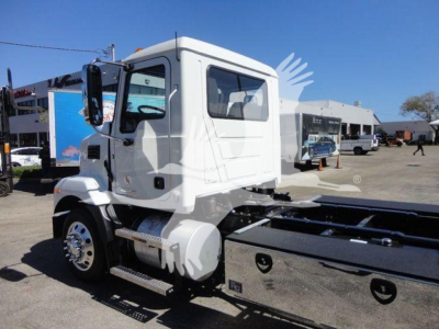 Truck cab side view showing MD6 roll-back truck chassis with side steps, fuel tank, and front wheel; cab label not legible.