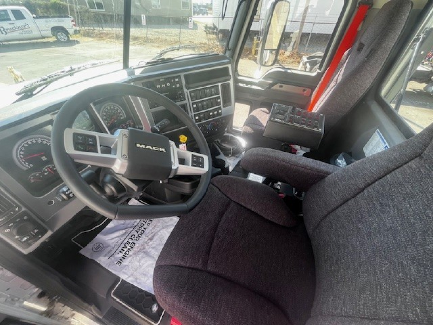 Mack GR84F truck cab interior showing steering wheel and dashboard with control cluster