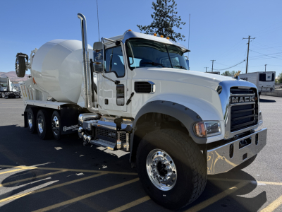 Mack GR84F cement mixer truck in white showing front grille, cab with chrome bumper, and mixer drum