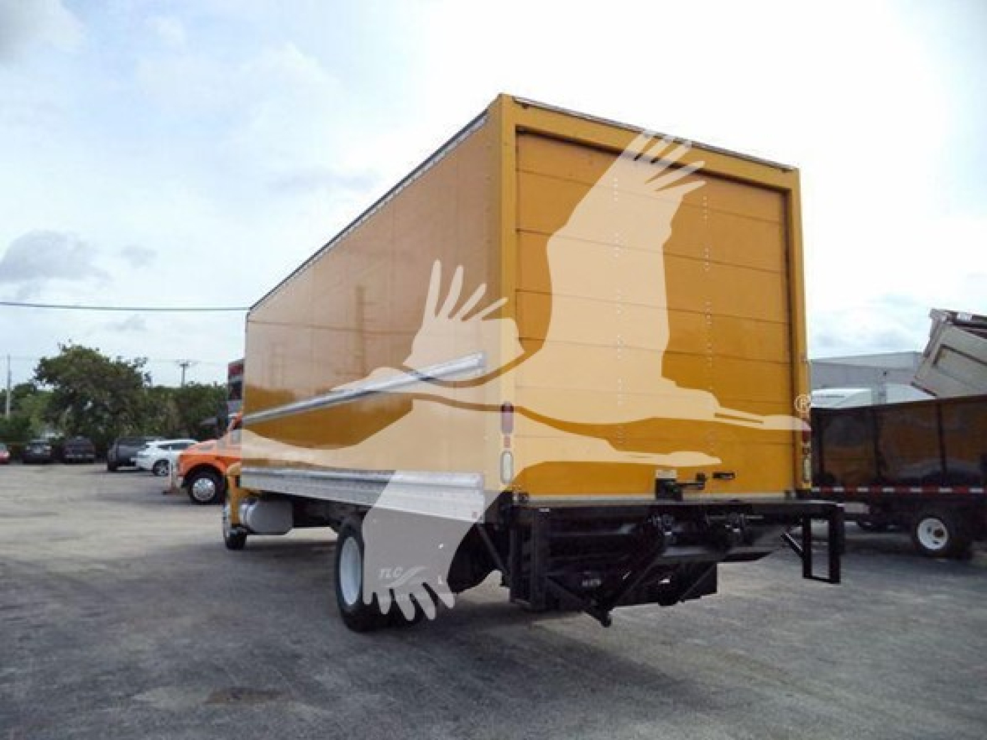 Box truck rear and side view showing cargo box and trailer hitch with black chassis and white rear doors