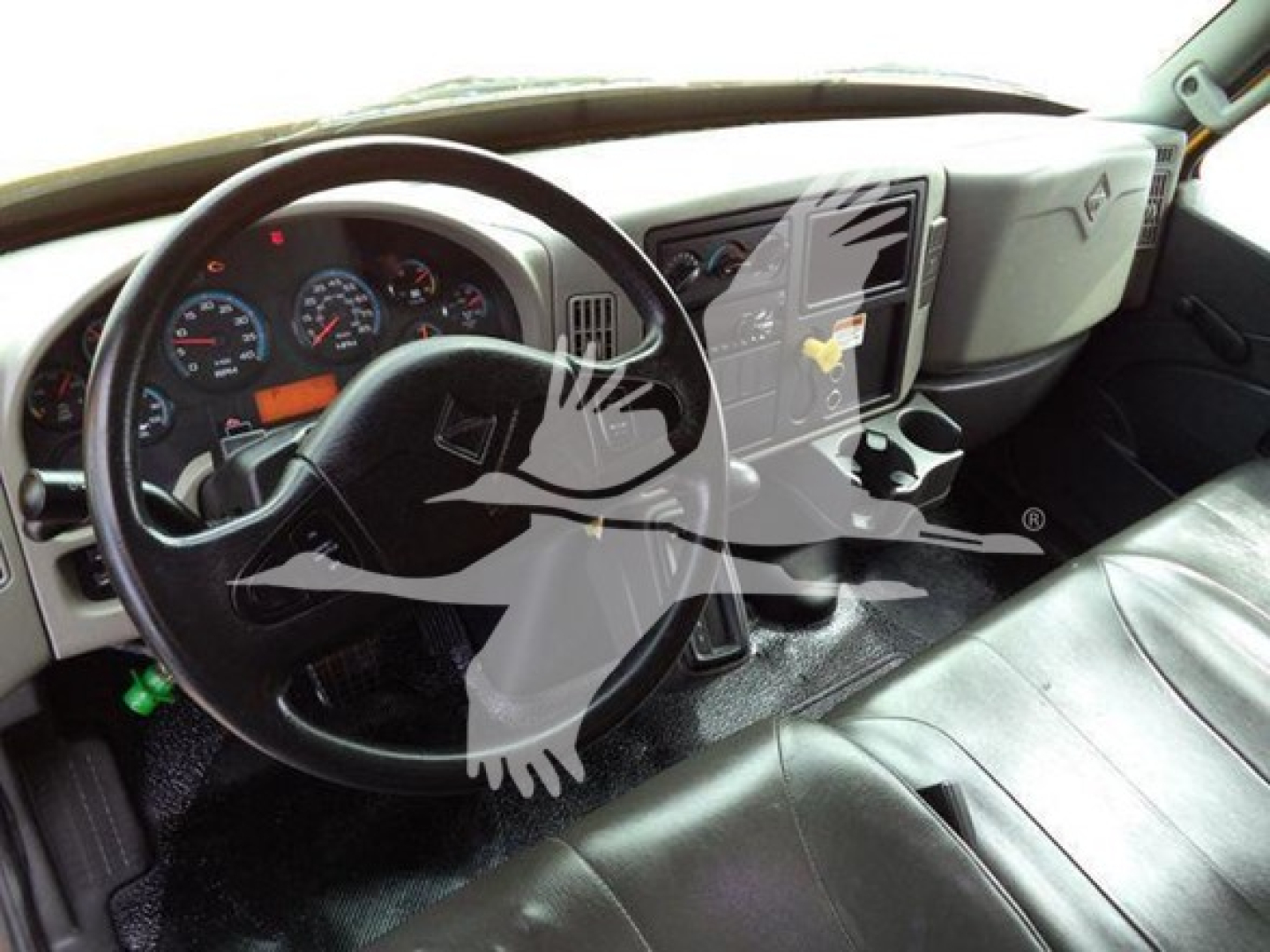 Truck cab interior of 2018 International Durastar 4300 showing steering wheel, dashboard gauges, and center controls.