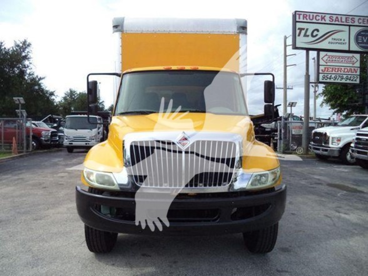 2018 International Durastar 4300 box truck, front view in yellow with large chrome grille, black bumper, side mirrors, and white cargo box. VIN and stock number not visible on front.