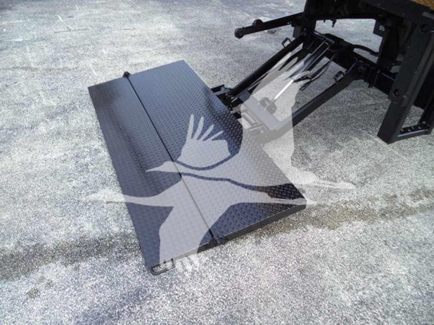 Truck lift or ramp platform on a 2018 International Durastar 4300 side view showing a diamond-plate access ramp attached to the truck chassis.