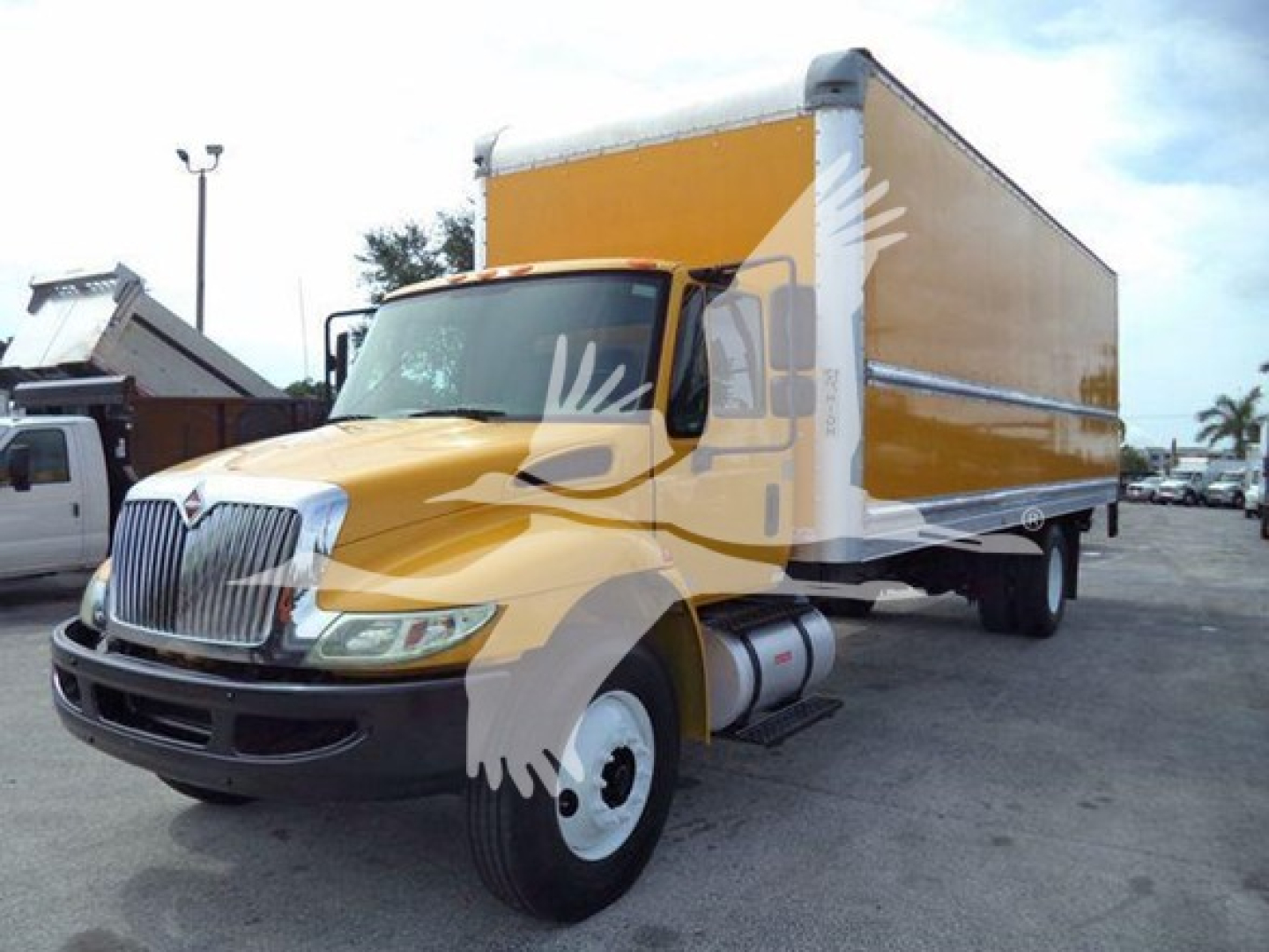 Box truck 2018 International Durastar 4300 in yellow cargo box, side view showing cab and front grille.