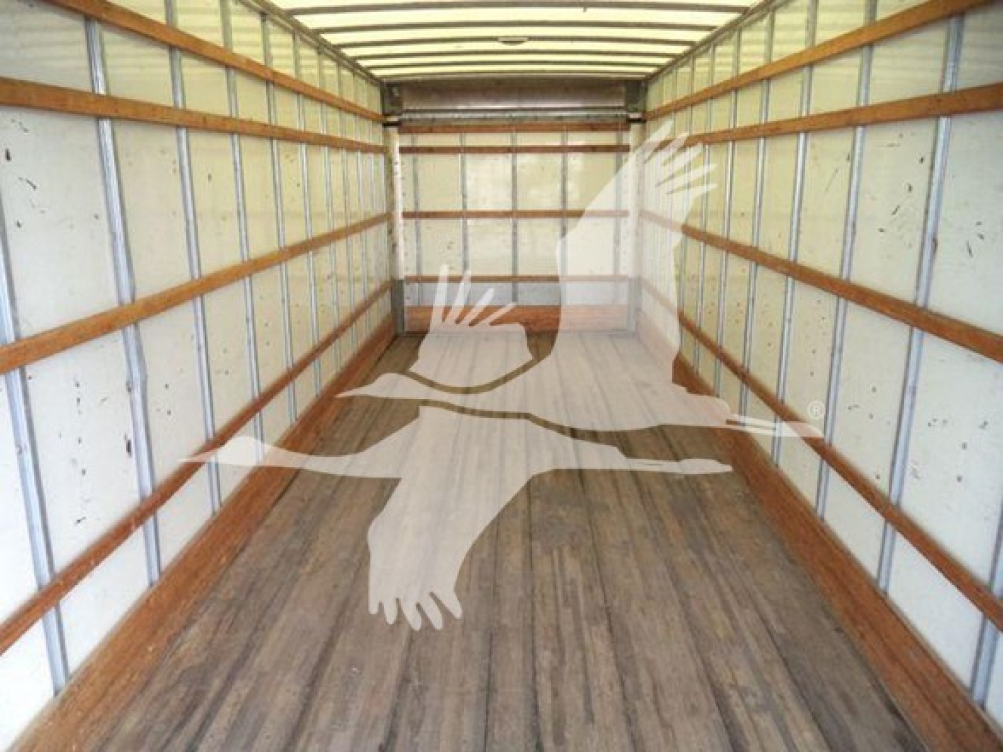 Box truck interior showing empty cargo area with wooden floor and metal side walls.