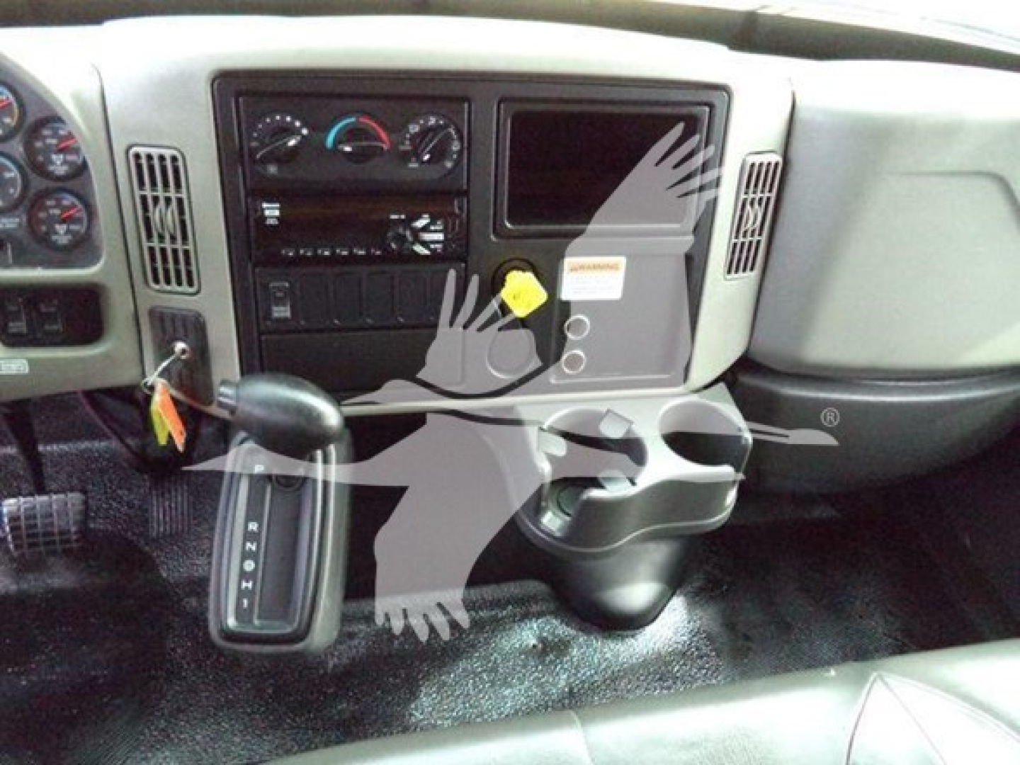 Cab interior of a 2018 International Durastar 4300 showing steering column, dashboard controls, gear selector, and center console.