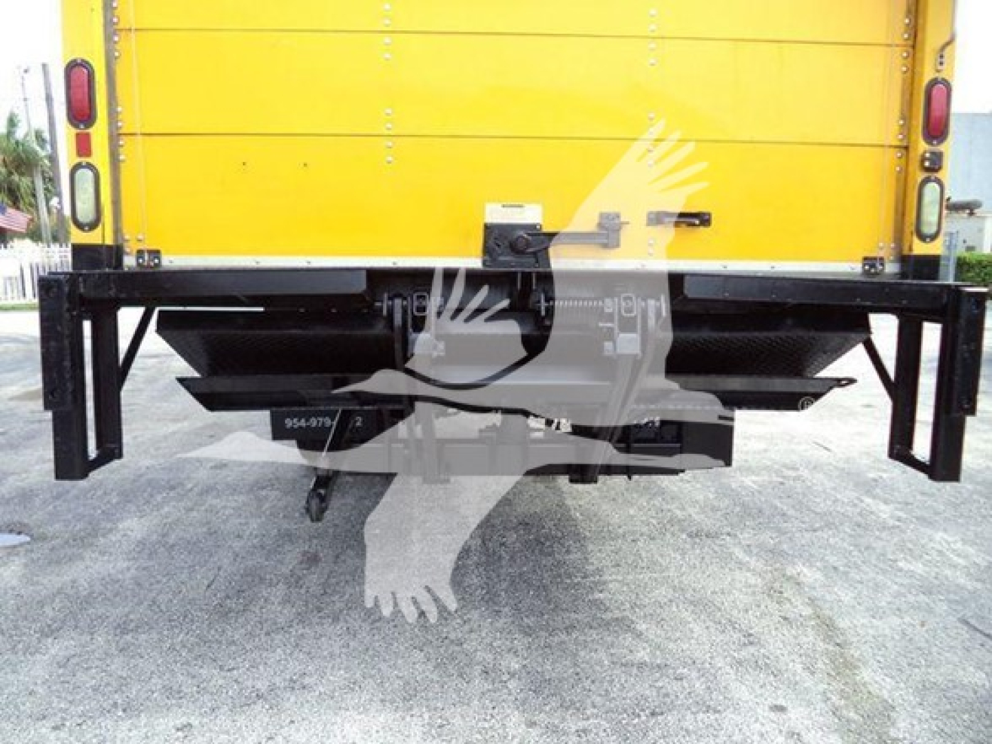 Back view of a yellow International Durastar 4300 box truck showing the rear bumper and hitch.