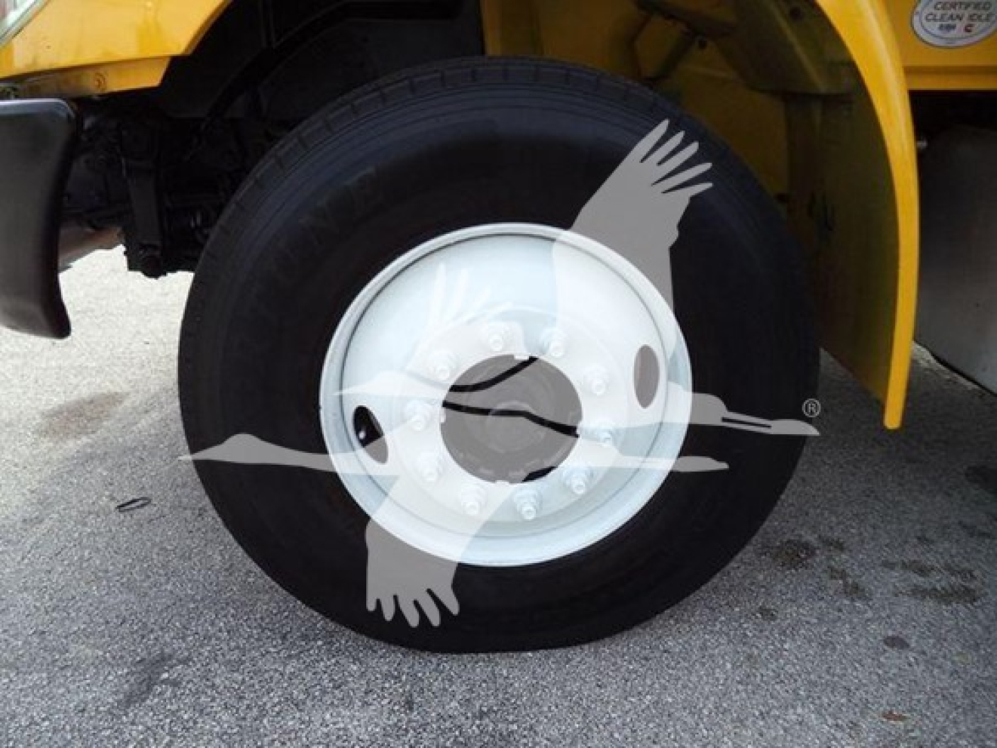 Wheel of a 2018 International Durastar 4300 stock image showing tire and white hub on right front corner.