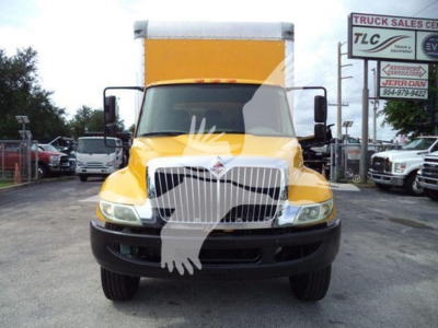 2018 International Durastar 4300 box truck, front view in yellow with large chrome grille, black bumper, side mirrors, and white cargo box. VIN and stock number not visible on front.
