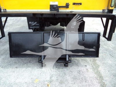 Truck rear showing hitch and a black rectangular toolbox/rack beneath a yellow Durastar 4300 cab. Visible text includes TLCs and contact numbers on the plate.
