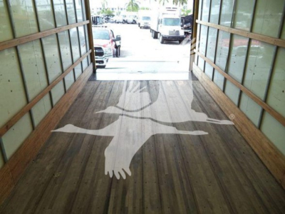 Truck interior showing wooden floor with deer logo graphic in the cargo area of a 2018 International Durastar 4300