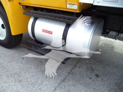 Fuel tank under a yellow International Durastar 4300 box truck showing cylindrical stainless fuel tank with black straps and steps nearby
