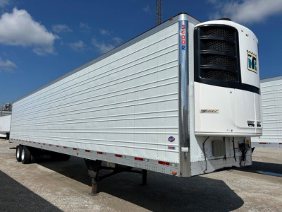 Trailer side view of a 2018 Utility Reefer with a Hyundai/LNG unit at the front; white refrigerated trailer with vertical ribbed sides and a cold storage unit at the nose.