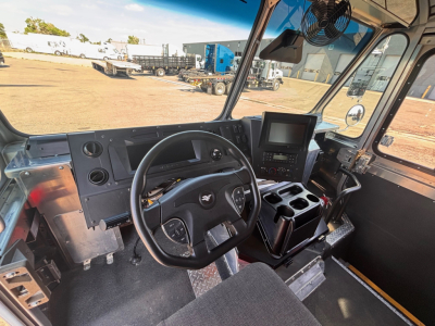 Harbinger S524 truck cab interior showing steering wheel, dashboard with gauge cluster, center control panel, and driver seat.