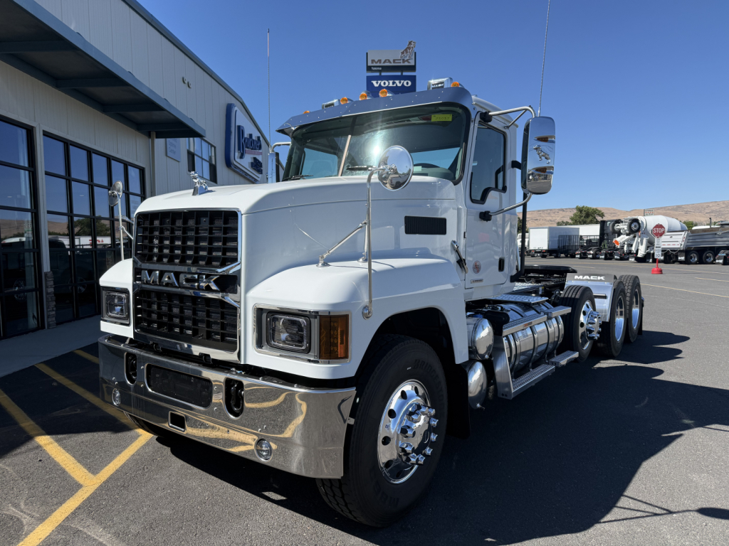 Mack PI84T conventional daycab truck showing chrome bumper and grille with dual rear axles.