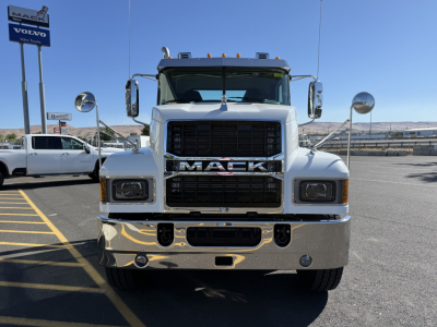Front view of a 2027 Mack PI84T conventional daycab truck showing grille, bumper, headlights, and large chrome front with Mack logo.