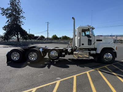 2027 Mack PI84T conventional daycab truck side view showing cab, exhaust stack, and multiple rear axles.