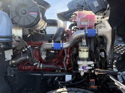 Mack PI84T engine bay showing turbo hoses, coolant reservoir, and fuel filter assembly.