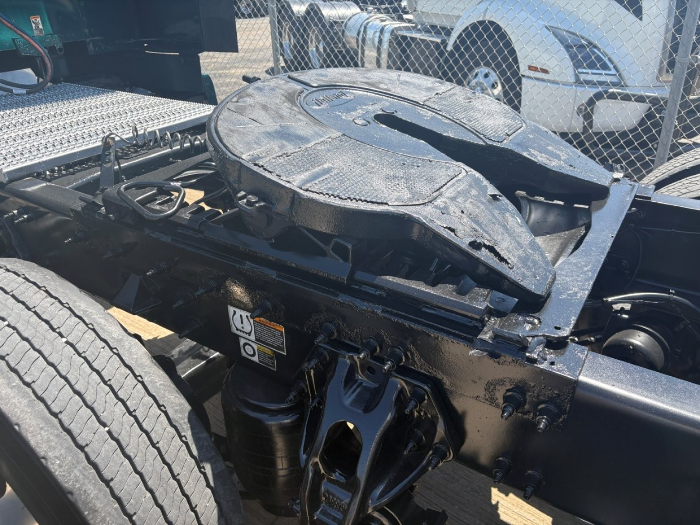 Truck fifth wheel and chassis area showing coupling and suspension components on a 2025 Peterbilt 579 used conventional sleeper truck.