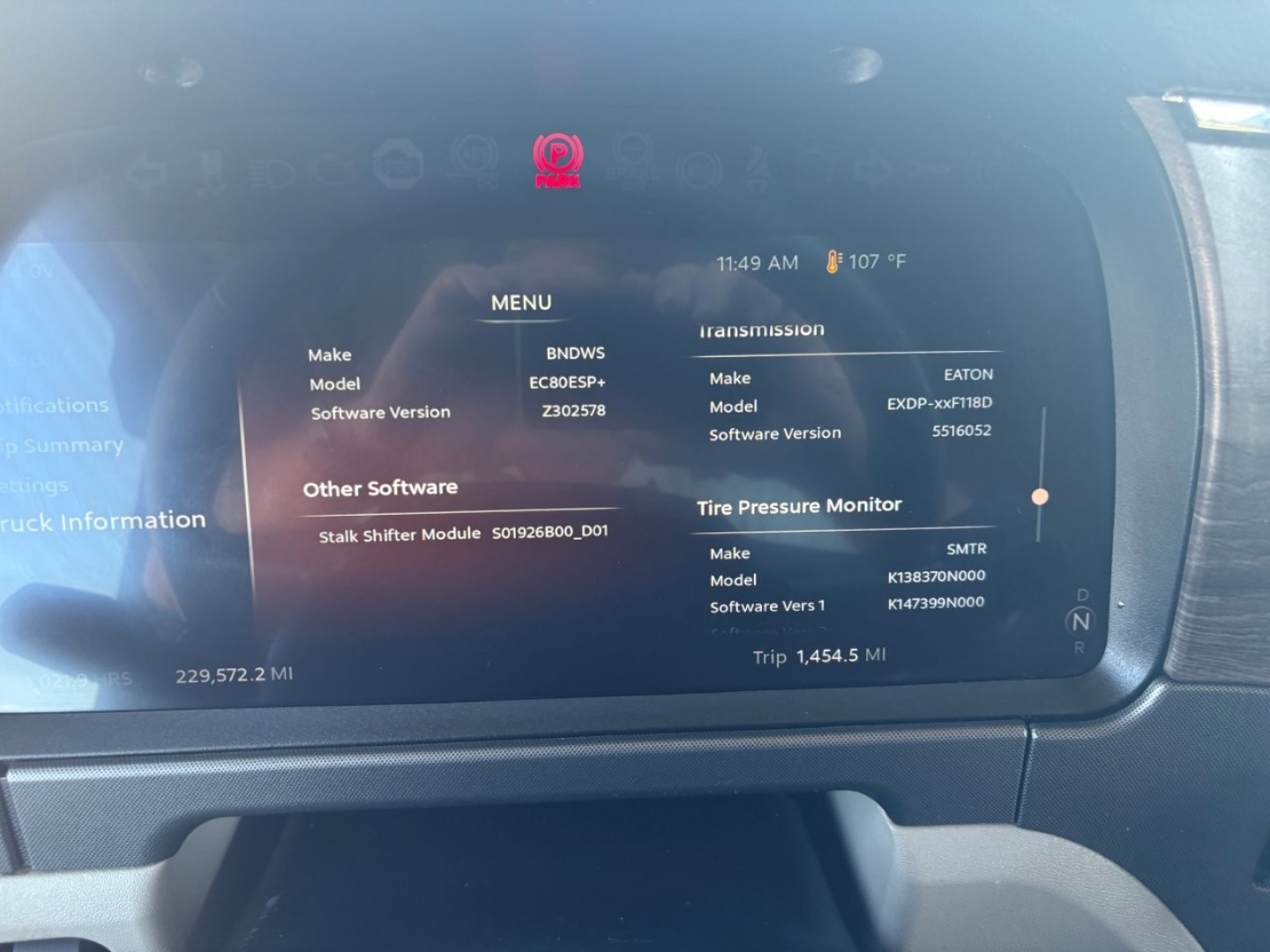 Peterbilt 579 dashboard display showing Menu with various software version numbers, tire pressure monitor, and trip data.