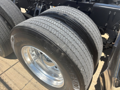 Peterbilt 579 truck rear dual tires on a drive axle, chrome wheel, visible frame and suspension components