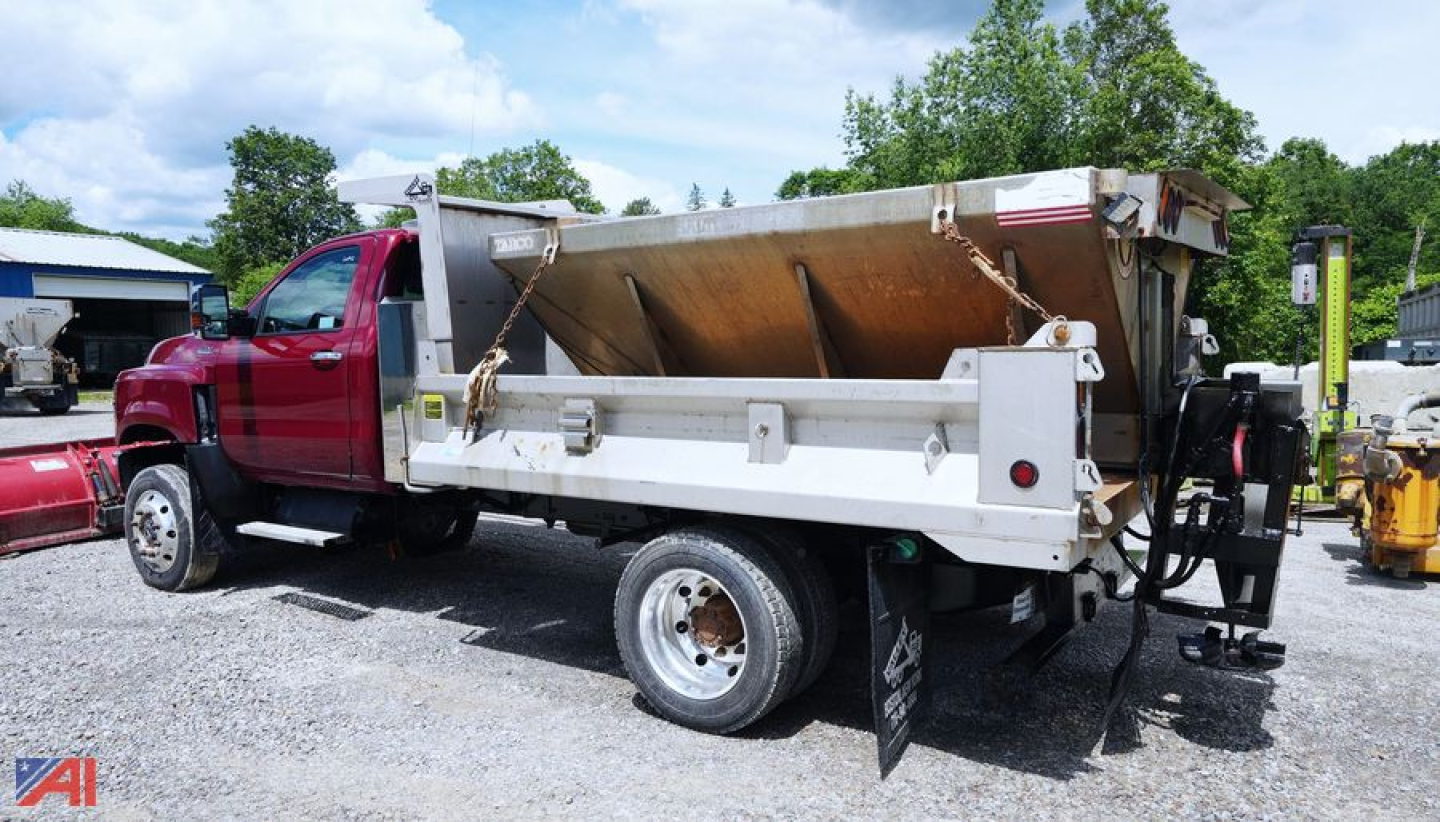 Dump truck with plow equipment side view showing International CV515 4x2 dump bed and plow mount behind cab.