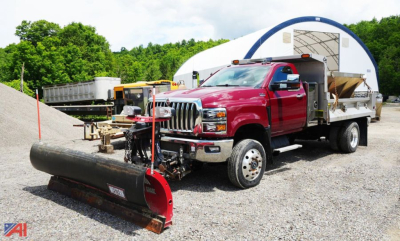 Vehicle front-left view of a red 2021 International CV515 SFA 4x2 dump and plow truck with a large snow plow attachment