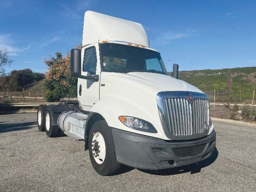 Truck cab showing International RH613 with chrome grille and white exterior.