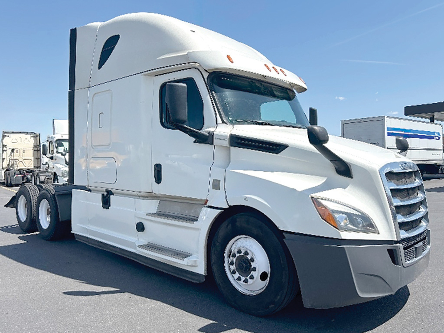 Freightliner Cascadia126 semi-truck tractor cab in white with sleeper, side view shows front grille, headlights, and wheels.
