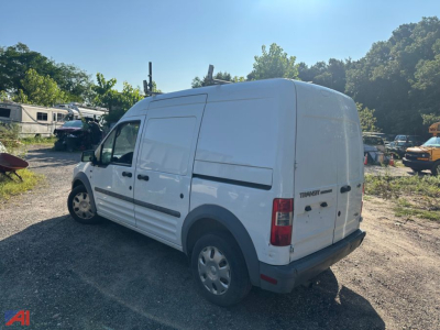 Ford Transit Connect cargo van viewed from rear-right side showing side panel and rear doors.